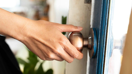 woman-holding-door-knob-1700318437.jpg